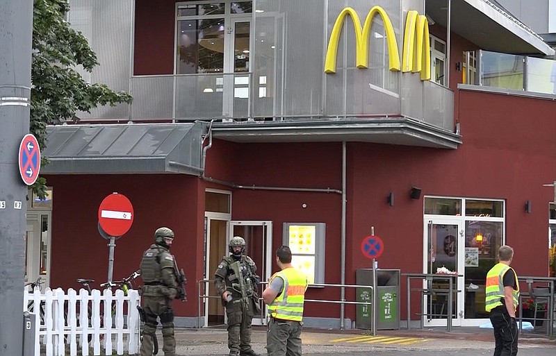 
              GERMANY OUT In this grab taken from video, police officers stand outside a McDonald's restaurant, near the mall, in Munich, Germany, Friday,  July 22, 2016. A manhunt was underway Friday for a shooter or shooters who opened fire at a shopping mall in Munich, killing and wounding several people, a Munich police spokeswoman said. The city transit system shut down and police asked people to avoid public places. (NONSTOP NEWS via AP)
            