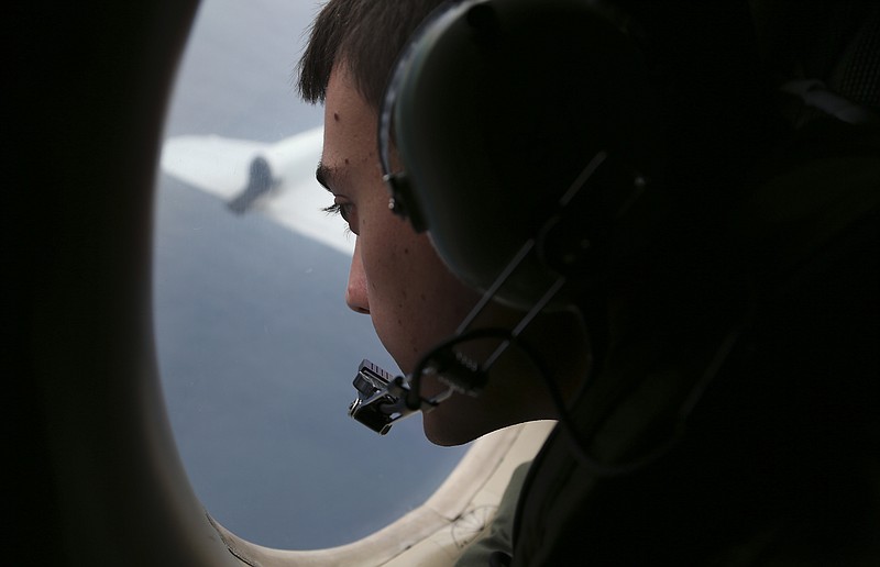 
              FILE - In this March 22, 2014 file photo, Sgt. Matthew Falanga on board a Royal Australian Air Force AP-3C Orion, search for the missing Malaysia Airlines flight MH370 in southern Indian Ocean, Australia. The hunt for Malaysia Airlines Flight 370 will be suspended once the current search area in the Indian Ocean has been completely scoured, the ministers of the three countries conducting the operation announced Friday, possibly ending all hopes of solving aviation's greatest mystery. (AP Photo/Rob Griffith, File)
            