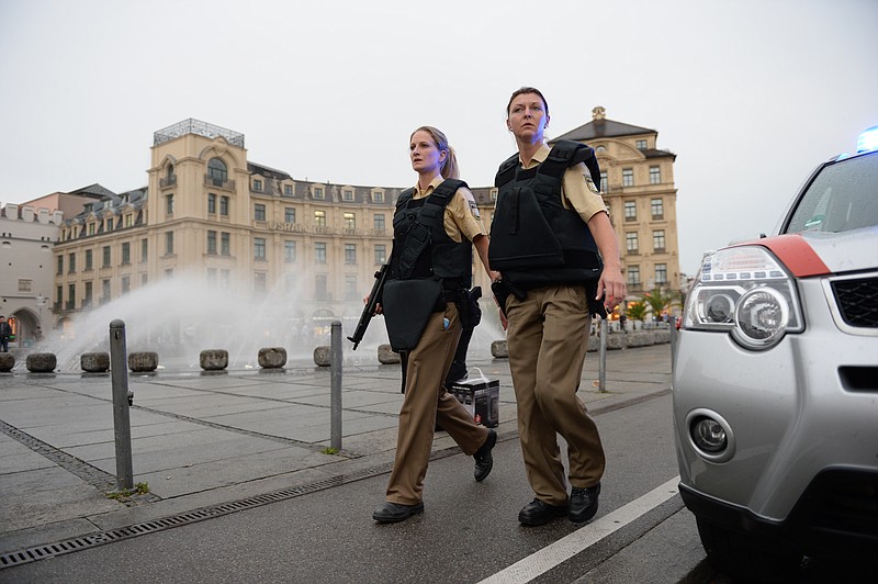 Police officers in protective gear woperate at Karlsplatz (Stachus) square after a shooting in the Olympia shopping centre was reported in Munich, southern Germany, Friday, July 22, 2016. (Andreas Gebert/dpa via AP)