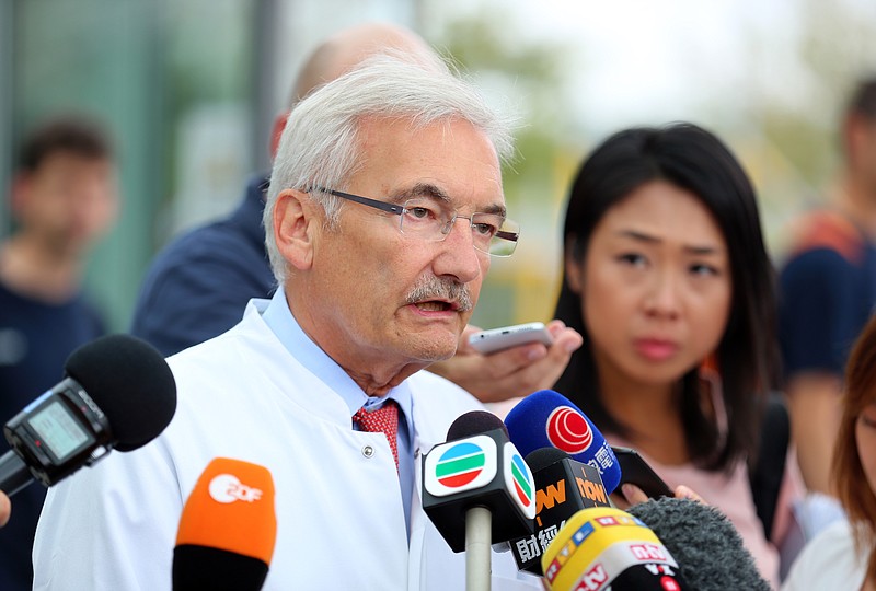 
              Medical director of the University Hospital in Wuerzburg,  Georg Ertl,  speaks to the media about the health condition of  victims of an ax and knife attack by a refugee in Wuerzburg, Germany, Thursday July 21, 2016.   Two Hong Kong tourists remained in a critical condition, the hospital treating them said Thursday, three days after they were attacked by an Afghan refugee wielding an ax and a knife on a German commuter train. The Islamic State group claimed responsibility for the attack.  ( Karl-Josef Hildenbrand/dpa via AP)
            