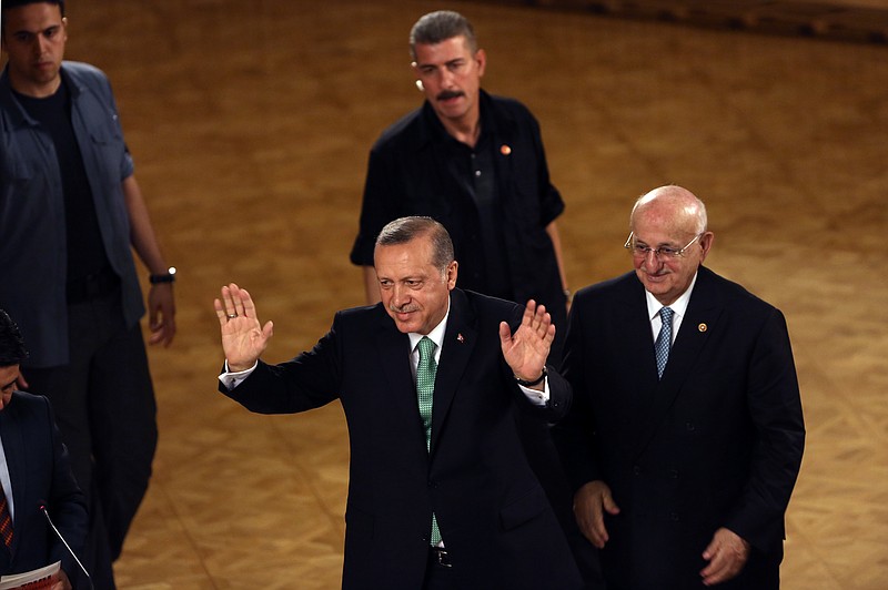 
              Turkey's President Recep Tayyip Erdogan salutes after his address at the parliament in Ankara, Turkey, Friday, July 22, 2016. Parliament voted 346-115 to approve the national state of emergency, which gives sweeping new powers to President Recep Tayyip Erdogan, who had been accused of autocratic conduct even before this week's crackdown on alleged opponents. Erdogan has said the state of emergency will counter threats to Turkish democracy. (AP Photo/Burhan Ozbilici)
            