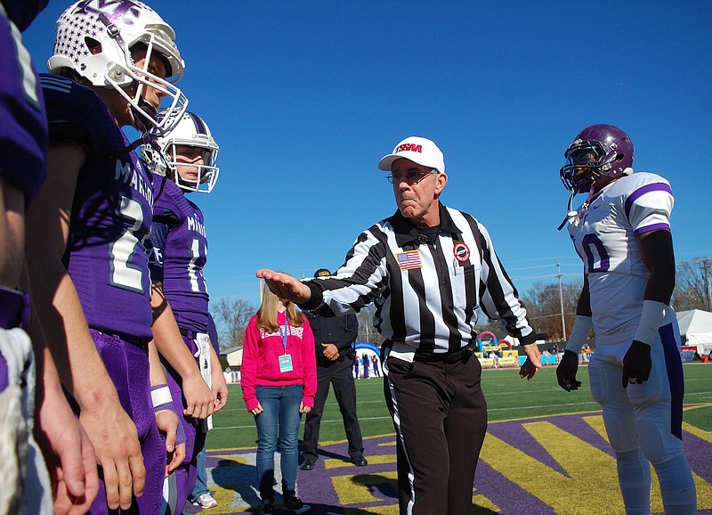 The referee shows the coin to the captains before the toss.  The Marion County Warriors faced the Trezevant Bears in the Division I Class 2A Tennessee State Football Championships in the BlueCross Bowl at Tennessee Tech's Tucker Stadium on Saturday, December 5, 2015.