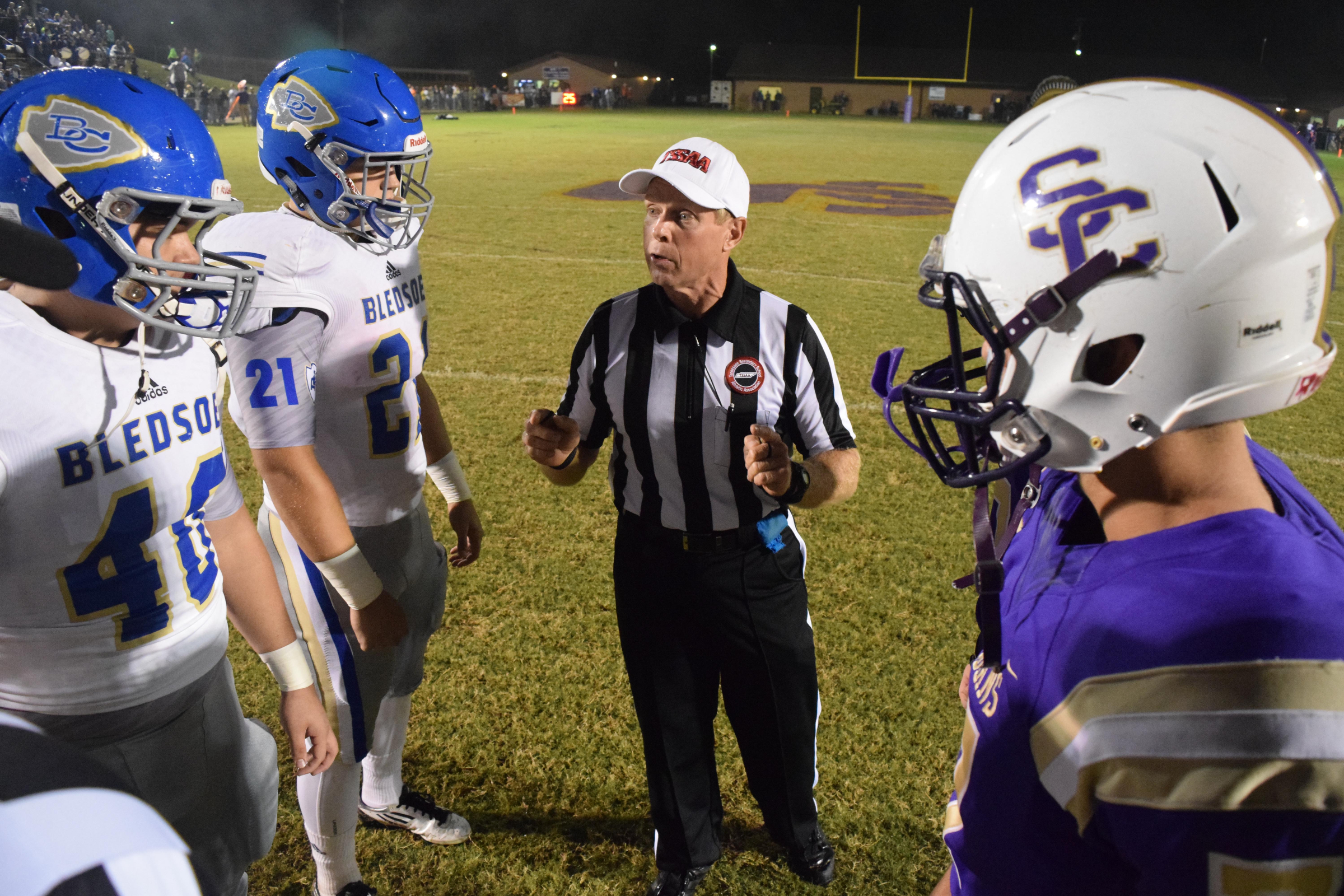 The referee instructs the captains before the coin toss.  The Bledsoe County Warriors visited the Sequatchie County Indians in TSSAA football action Saturday September 25, 2015.