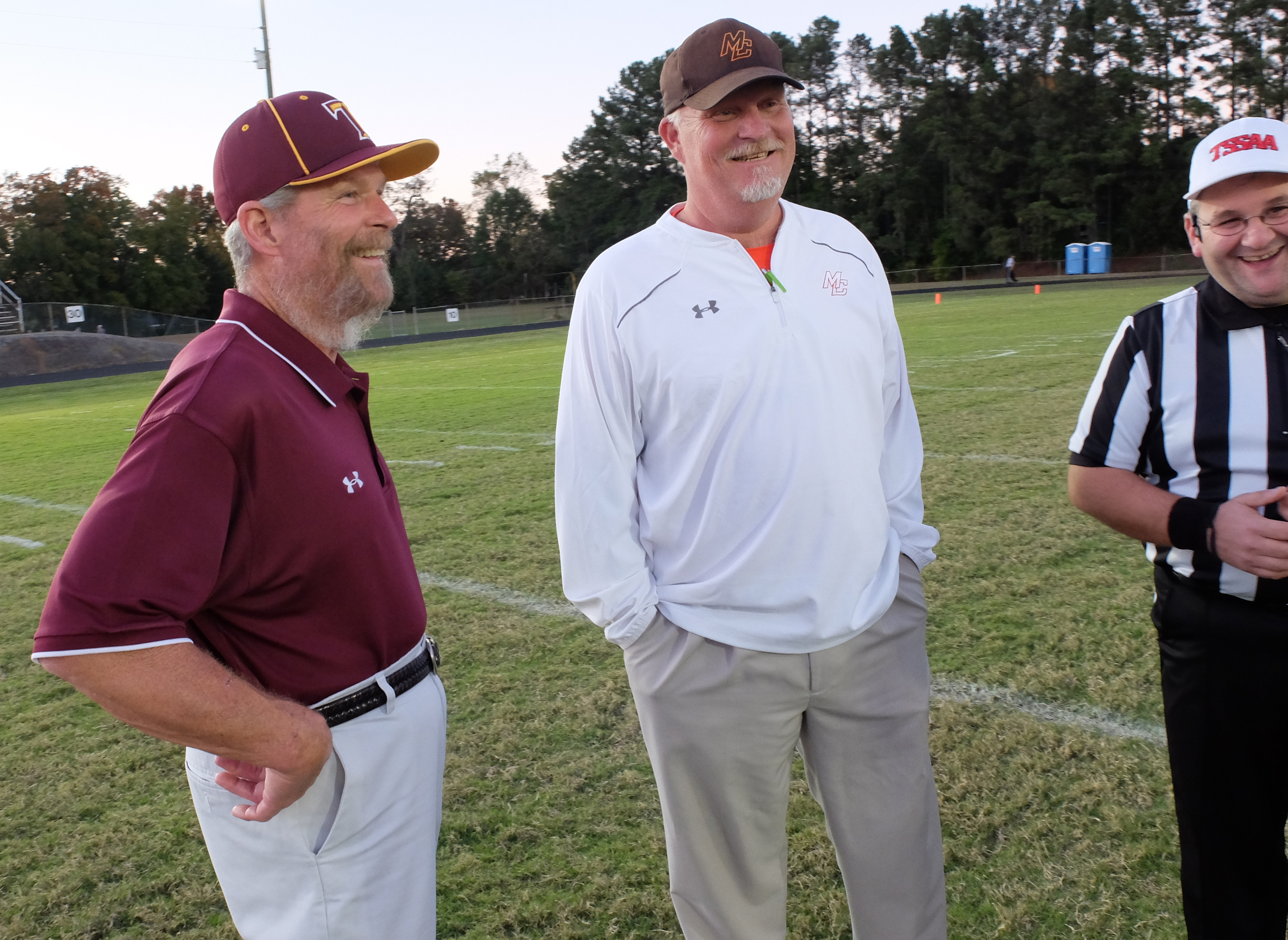 Tyner coach Wayne Turner, left, and Meigs County coach Jason Fitzgerald enjoy a lighter moment with head referee Marc O'Neal before Friday's game.