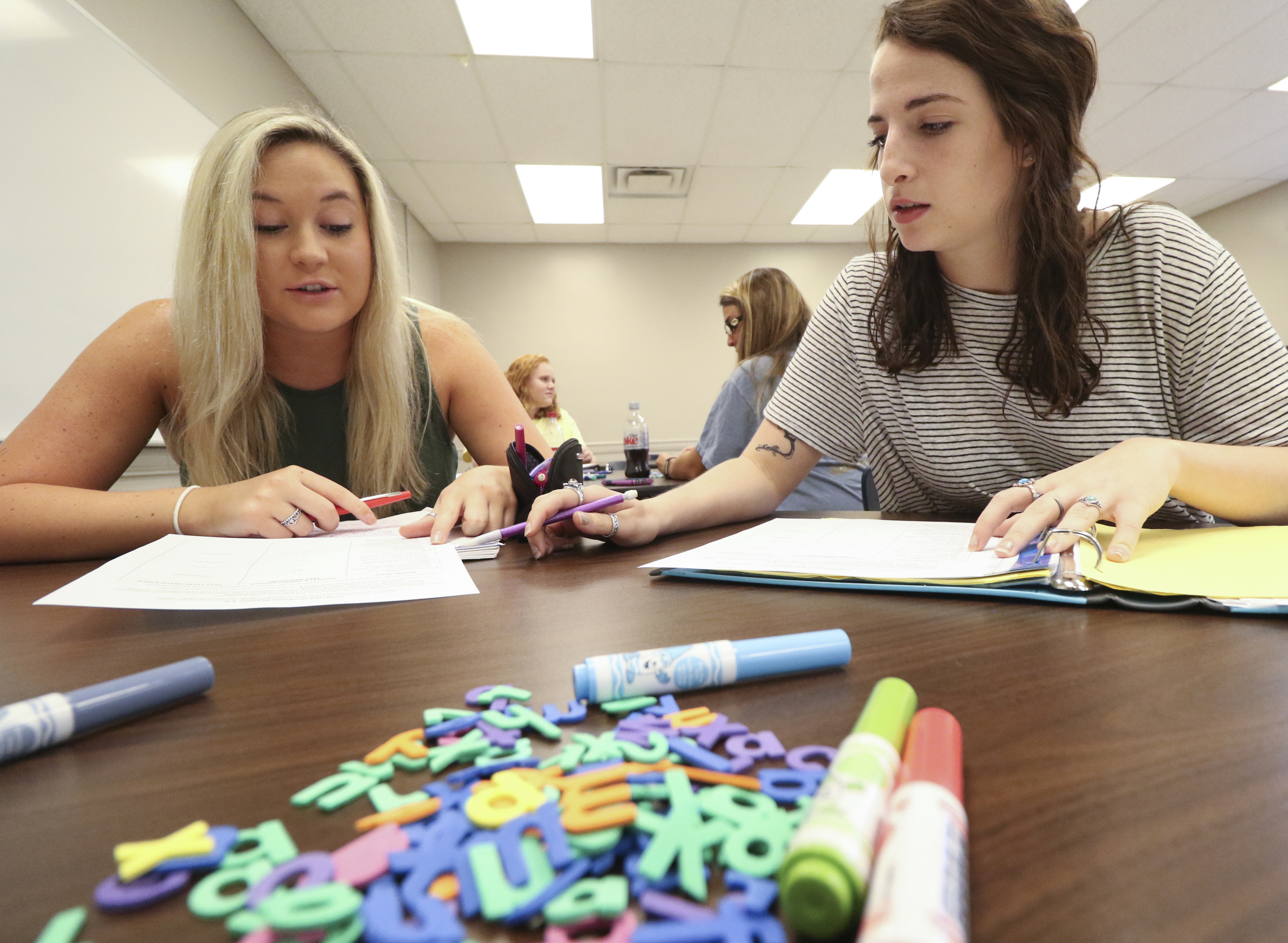 Staff Photo by Dan Henry / The Chattanooga Times Free Press- 7/21/16. Whitney Steadman, left, and Micah WIlkins work on a "Rainbow Writing" exercise as Dr. Sarah Sandefur speaks about emergent literacy while at the University of Tennessee at Chattanooga on Thursday, July 21, 2016.