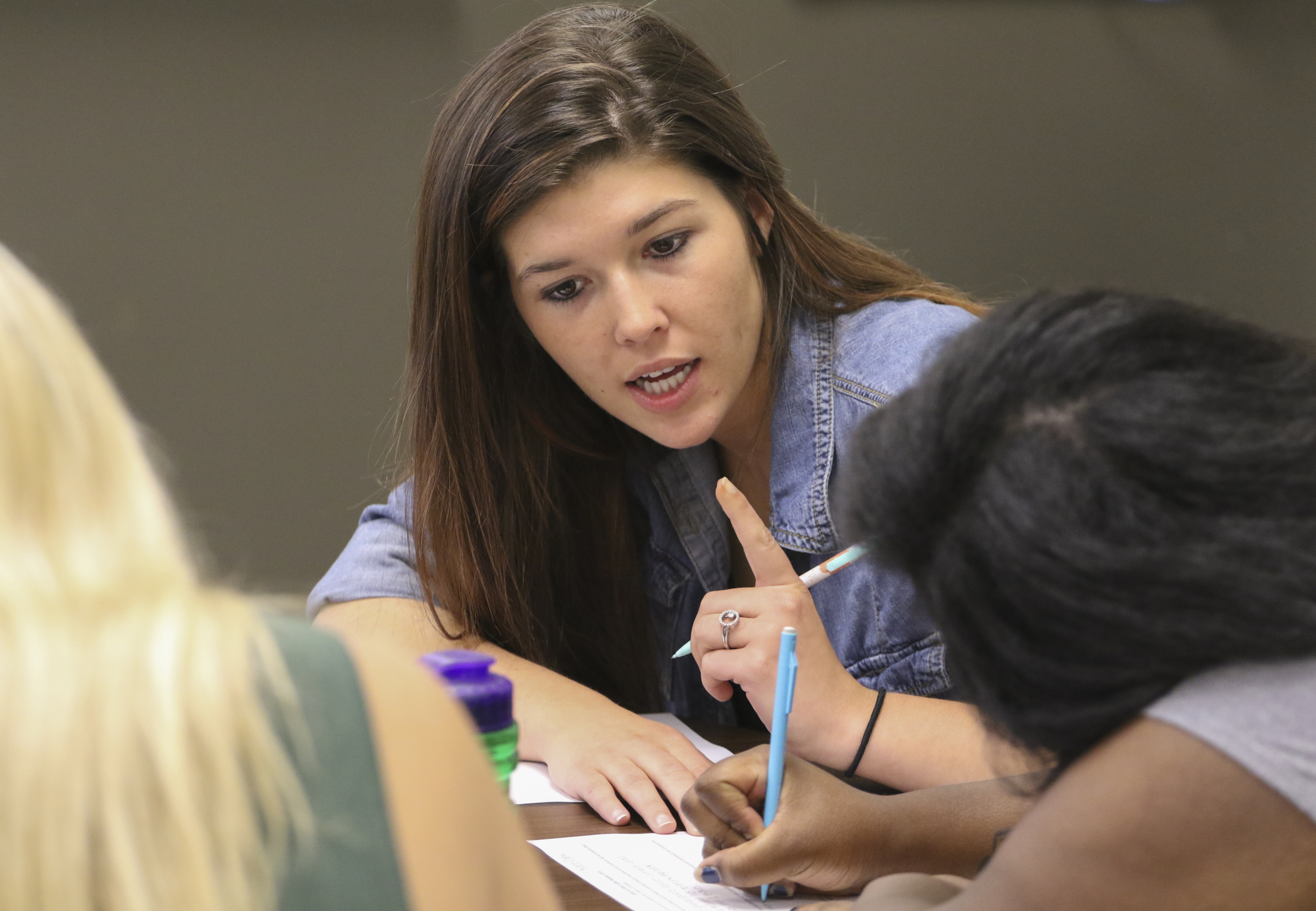 Staff Photo by Dan Henry / The Chattanooga Times Free Press- 7/21/16. Kalee Cook works with her teammate on a quiz after Dr. Sarah Sandefur spoke about emergent literacy while at her University of Tennessee at Chattanooga class on Thursday, July 21, 2016.