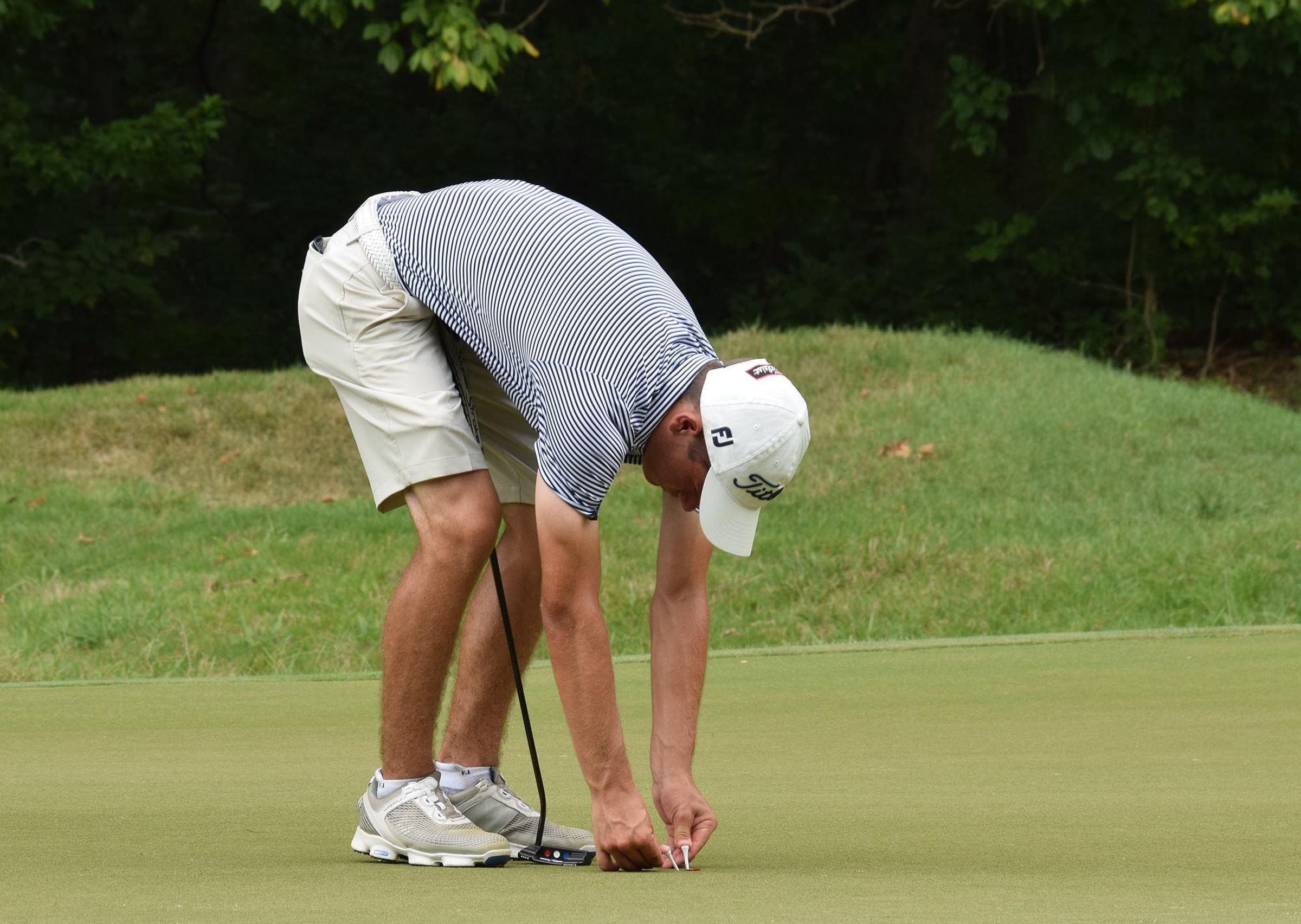 Noah Goodwin of Cornith, Texas marks his place on the 32nd hole has play is called for weather.  The final day of the 69th U.S. Junior Amateur Championship was held at the Honors Course in Ooltewah, Tennessee, Saturday July 23, 2016.