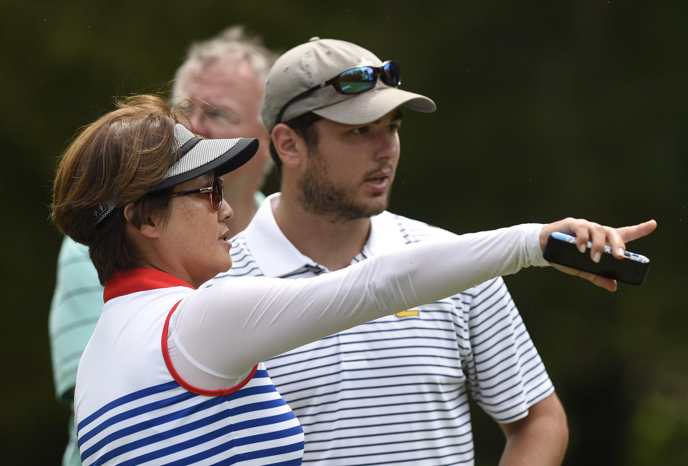 Australia's Min Woo Lee mother, Clara, discusses the course with Brian Beck.  Beck caddies at the Honors Course.  The final day of the 69th U.S. Junior Amateur Championship was held at the Honors Course in Ooltewah, Tennessee, Saturday July 23, 2016.