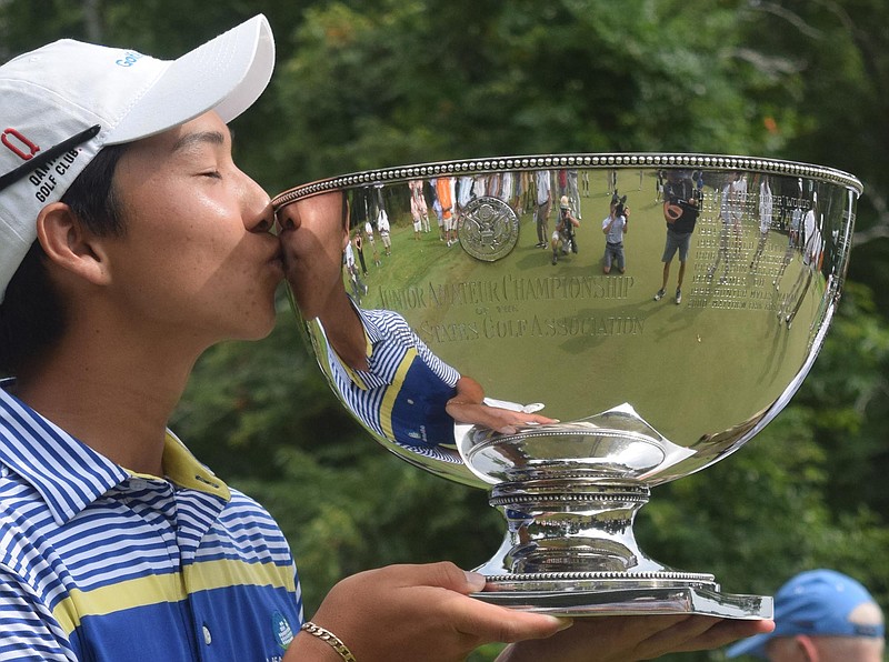 Australia's Min Woo Lee kisses the trophy after winning the championship.  The final day of the 69th U.S. Junior Amateur Championship was held at the Honors Course in Ooltewah, Tennessee, Saturday July 23, 2016. 