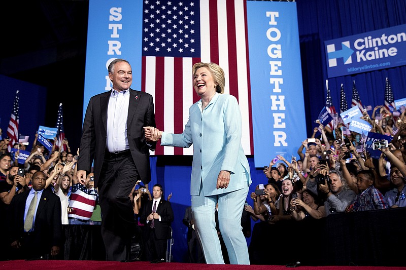 
              Democratic presidential candidate Hillary Clinton and Sen. Tim Kaine, D-Va., take the stage together at a rally at Florida International University Panther Arena in Miami, Saturday, July 23, 2016. Clinton has chosen Kaine to be her running mate. (AP Photo/Andrew Harnik)
            