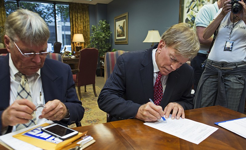 
              Former Ku Klux Klan leader David Duke registers his candidacy for the November 8 ballot as a Republican at the Louisiana Secretary of State's office in Baton Rouge, La., Friday, July 22, 2016. Duke's candidacy comes as the state is grappling with deep racial tensions after the shooting death of a black man by white police officers and the killing of three law enforcement officers by a black man. (AP Photo/Max Becherer)
            