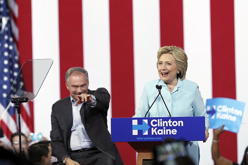 Democratic presidential candidate Hillary Clinton is joined by Sen. Tim Kaine, D-Va., as she speaks at a rally at Florida International University Panther Arena in Miami, Saturday. Clinton has chosen Kaine to be her running mate. (AP Photo/Mary Altaffer)
