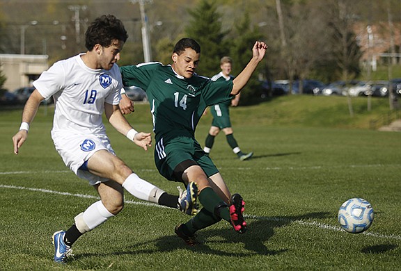 McCallie's Drew Viscomi (19) takes a shot on the goal around Notre Dame's Conner Henry during their soccer match at McCallie School on Wednesday, March 23, 2016, in Chattanooga, Tenn.