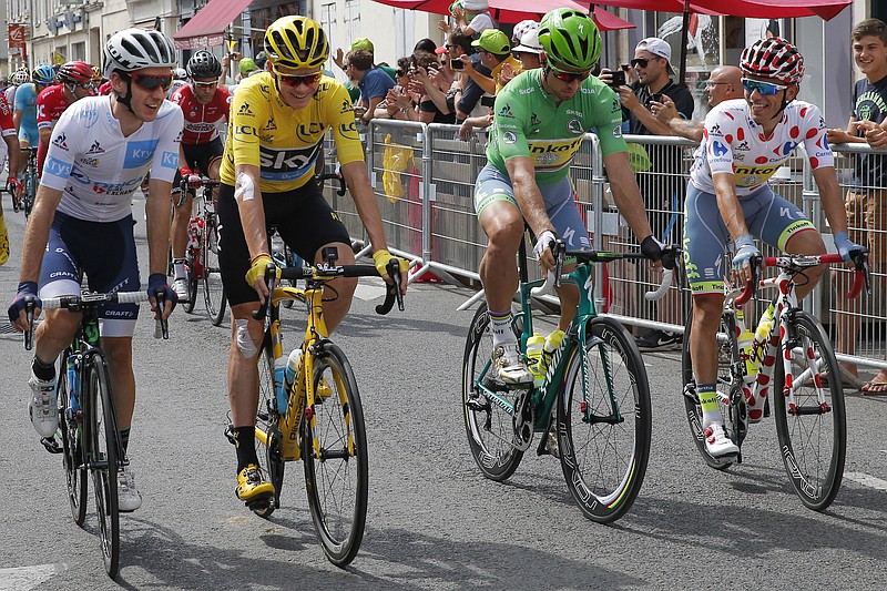 
              Britain's Chris Froome, wearing the overall leader's yellow jersey, Slovakia's Peter Sagan, wearing the best sprinter's green jersey, Poland's Rafal Majka, wearing the best climber's dotted jersey and Britain's Adam Yates, wearing the best young rider's white jersey, ride in the ceremonial parade preceding the twenty-first stage of the Tour de France cycling race over 113 kilometers (70.2 miles) with start in Chantilly and finish in Paris, France, Sunday, July 24, 2016. (AP Photo/Christophe Ena)
            