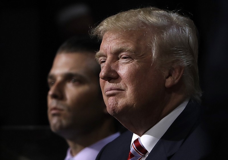 
              File- Thgis July 20, 2016, file photo shows Republican Presidential Candidate Donald Trump, right, and his son Donald Trump, Jr., watching as Eric Trump addresses the delegates during the third day session of the Republican National Convention in Cleveland.  Trump is asserting that countries like France that he says are compromised by terrorism may be subjected to the “extreme vetting” he proposes as a deterrent to attacks in the U.S. When asked if his proposal might lead to a point when not a lot of people from overseas are allowed into the U.S., Trump said, “Maybe we get to that point” and added: “We have to be smart and we have to be vigilant and we have to be strong.” (AP Photo/Matt Rourke, File)
            