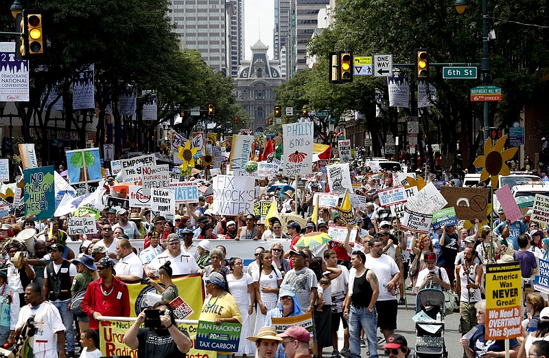 
              Protesters march during a demonstration in downtown on Sunday, July 24, 2016, in Philadelphia. The Democratic National Convention starts Monday. (AP Photo/Alex Brandon)
            