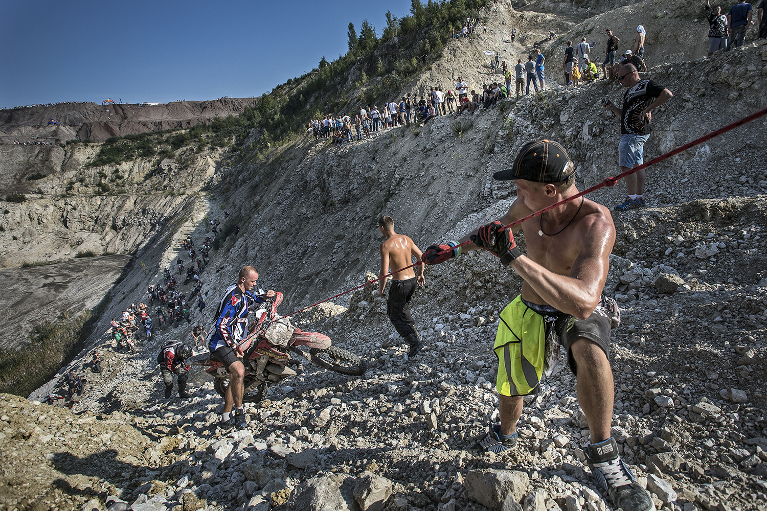 Spectators and the crew help a competitor to get his machine up the most difficult ascent of the Red Bull 111 Megawatt in Belchatow, Poland. Photo by Tomek Gola/Red Bull Content Pool.