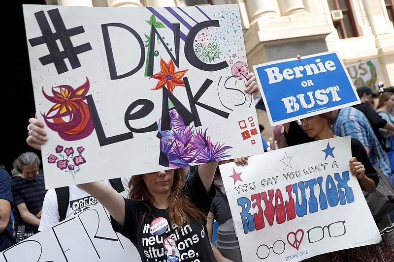 Demonstrators make their way around downtown Monday in Philadelphia during the first day of the Democratic National Convention. On Sunday, Debbie Wasserman Schultz, D-Fla., announced she would step down as DNC chairwoman at the end of the party's convention, after nearly 20,000 emails, presumably stolen from the DNC by hackers, were posted to the website Wikileaks. (AP Photo/John Minchillo)