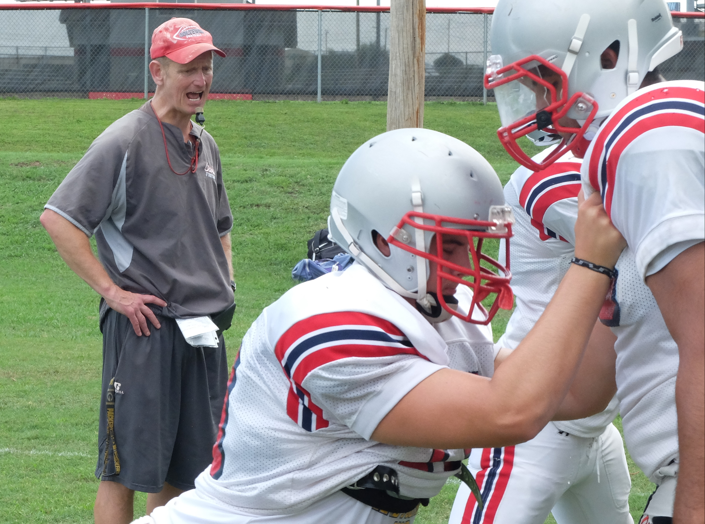 Coach Mac Bryan begins work with his linemen during practice on Monday.