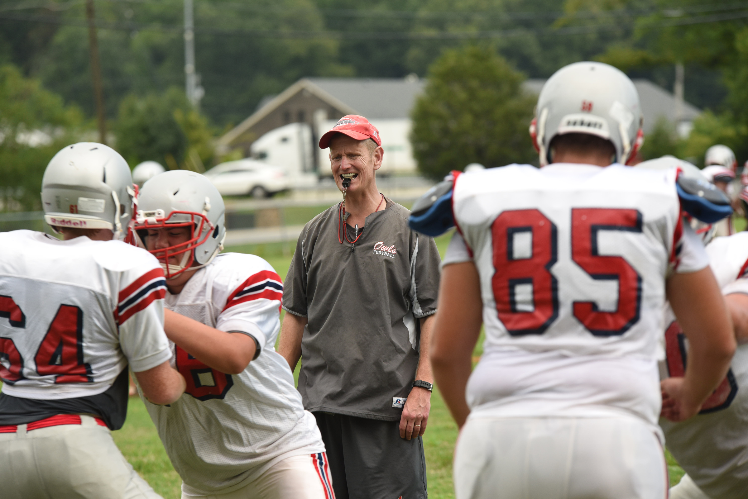 Coach Mac Bryan begins work with his linemen during practice on Monday.