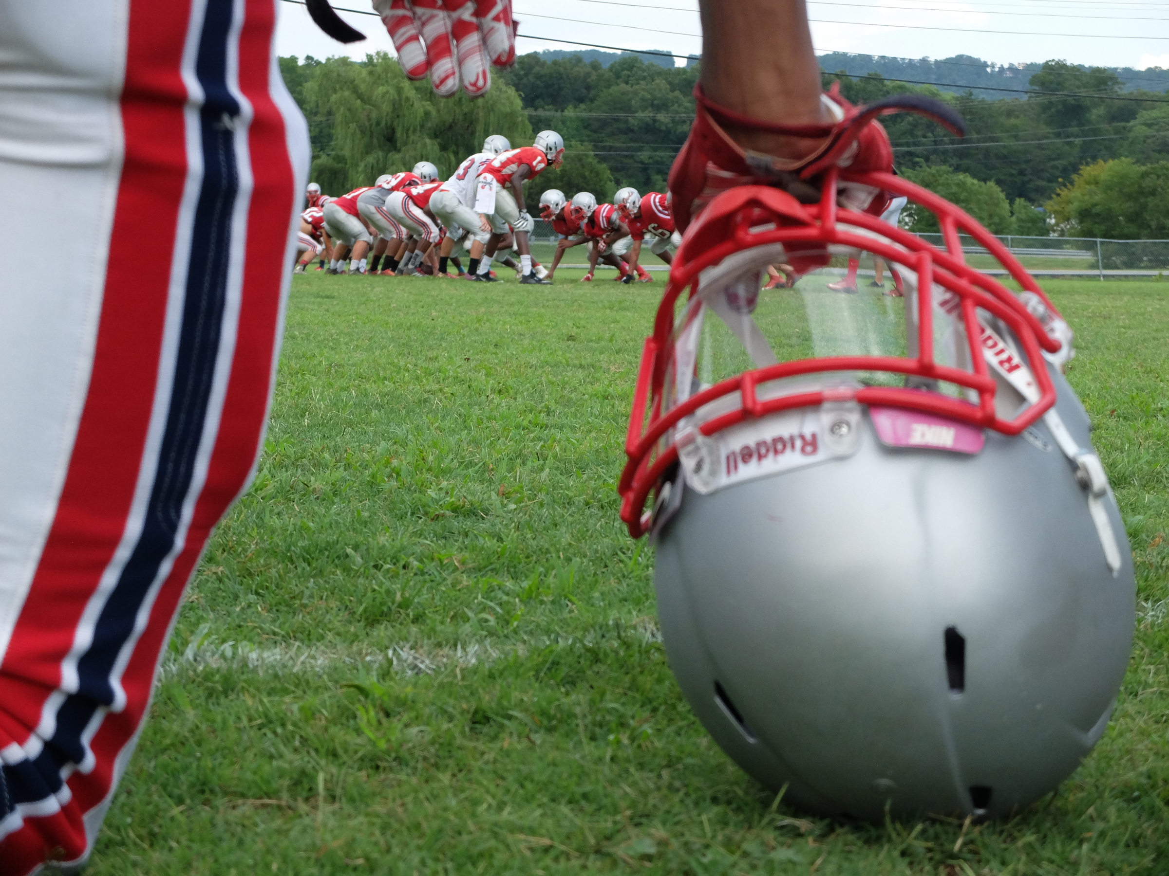 Coach Mac Bryan's Ooltewah Owls line up on the practice field after a rain late Monday.
