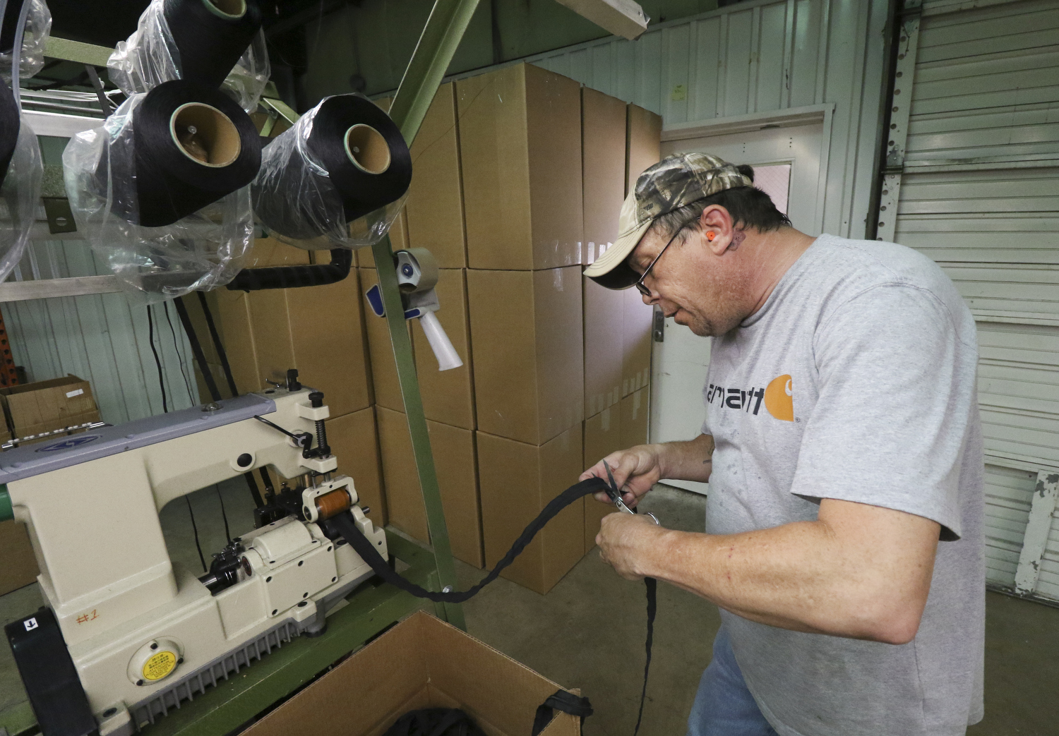 Staff Photo by Dan Henry / The Chattanooga Times Free Press- 7/25/16. John Smith, a mechanic with Dunlap Industries, works on a coil zipper sewing machine on Monday, July 25, 2016. DI makes molded and coil zippers for use with U.S. Army and other high use applications.