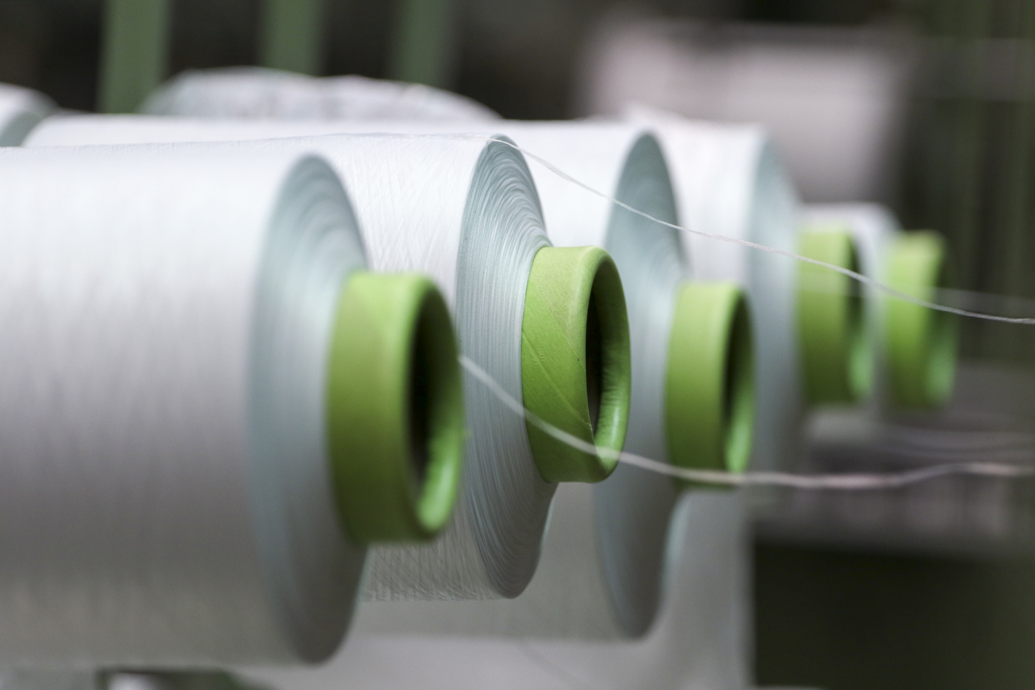 Staff Photo by Dan Henry / The Chattanooga Times Free Press- 7/25/16. Spools on a creel feed into machines weaving the tape used to make zippers at Dunlap Industries on Monday, July 25, 2016. DI makes molded and coil zippers for use with U.S. Army and other high use applications.