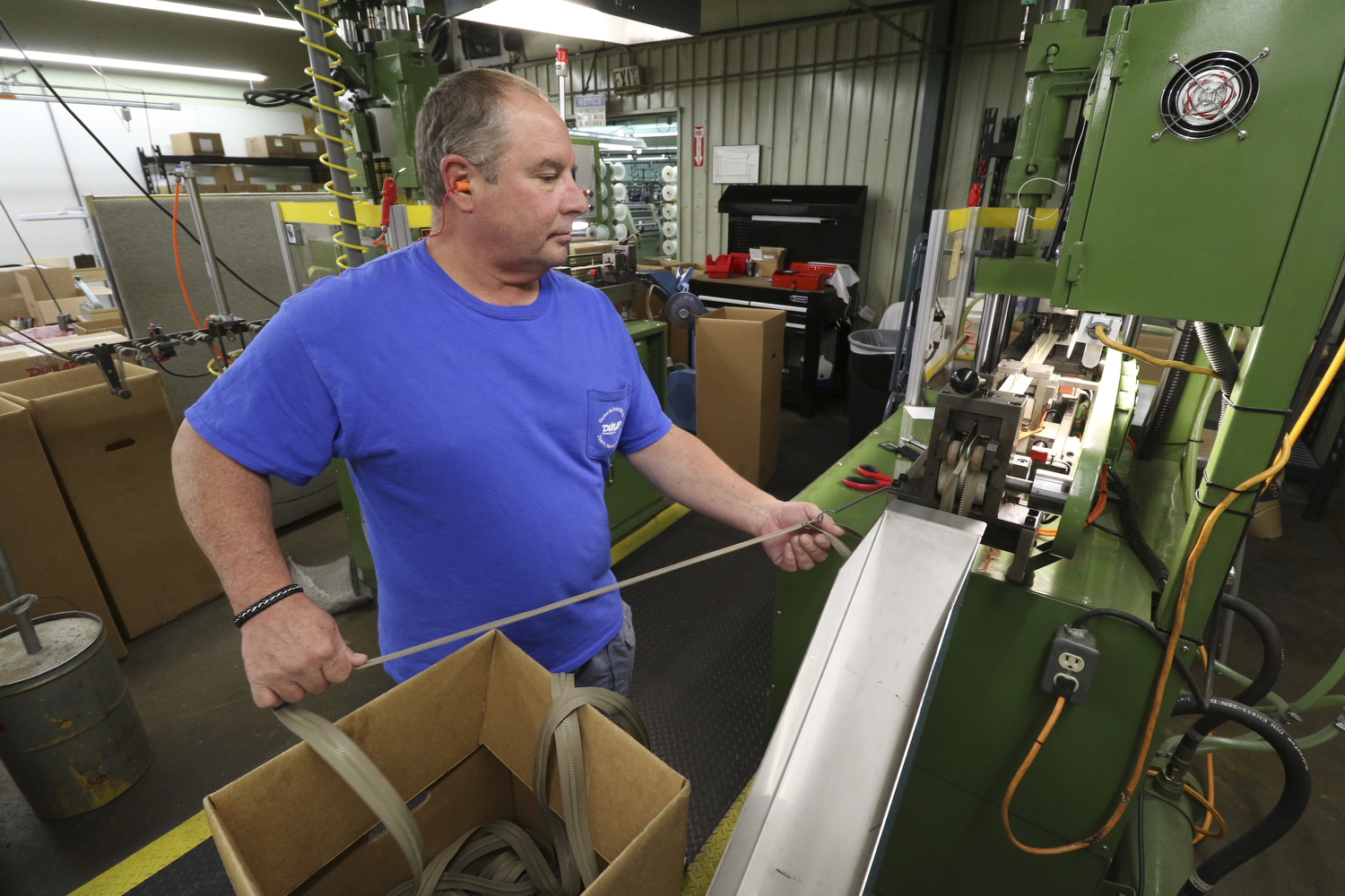 Staff Photo by Dan Henry / The Chattanooga Times Free Press- 7/25/16. James Kofel molds 6" zippers at Dunlap Industries on Monday, July 25, 2016. DI makes molded and coil zippers for use with U.S. Army and other high use applications.
