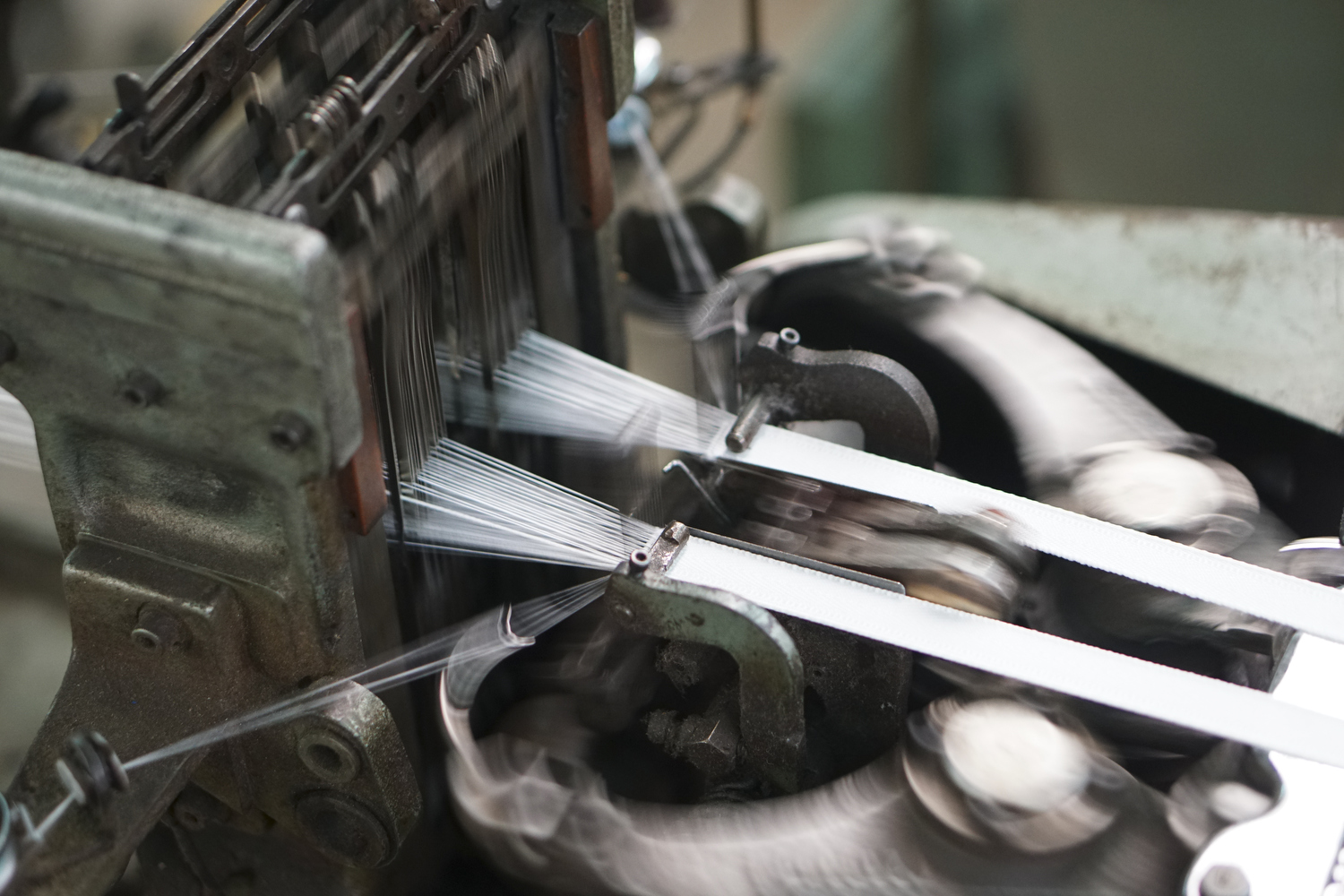 Staff Photo by Dan Henry / The Chattanooga Times Free Press- 7/25/16. Threads are being woven into zipper tape at Dunlap Industries on Monday, July 25, 2016. DI makes molded and coil zippers for use with U.S. Army and other high use applications.