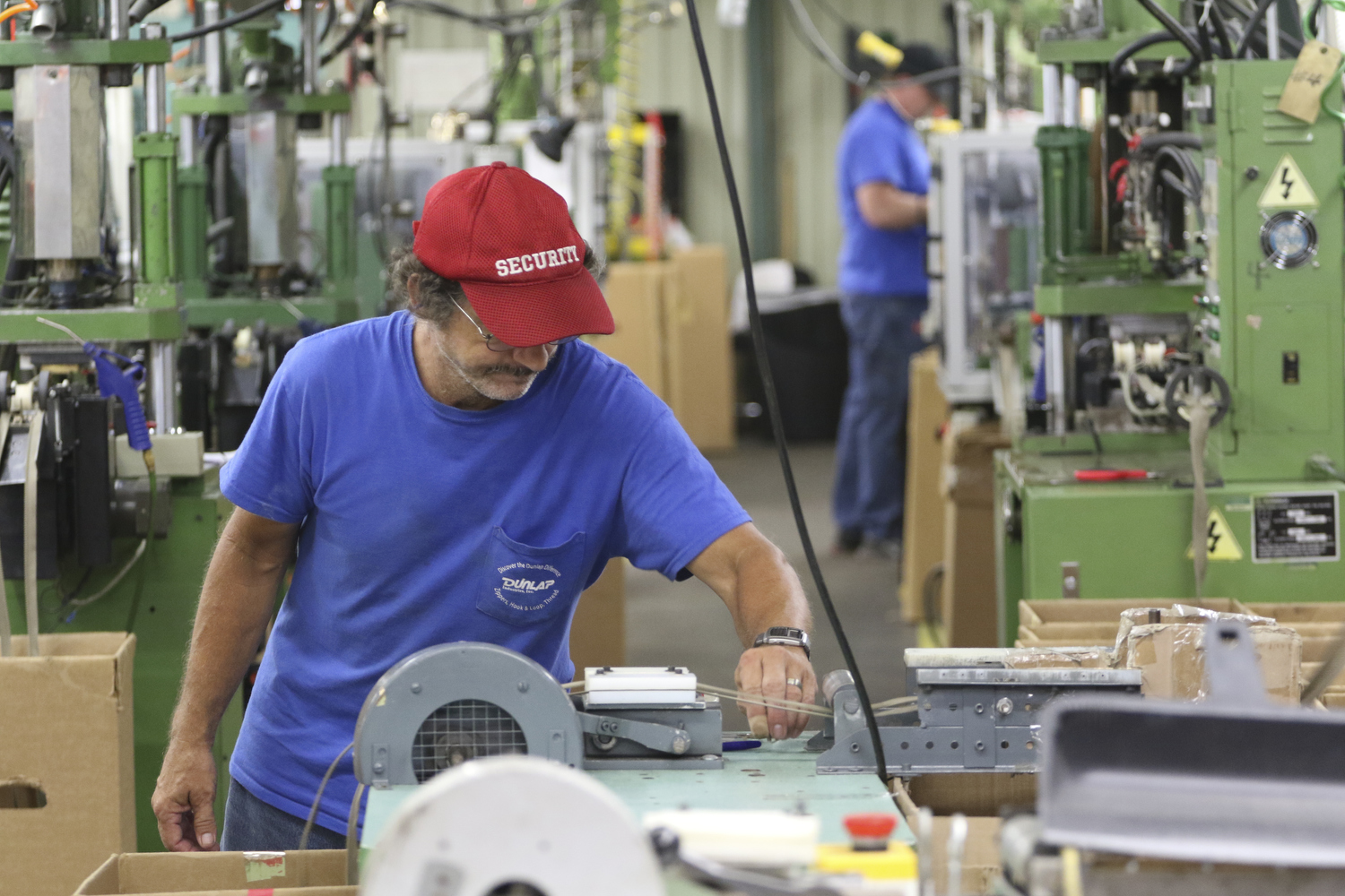 Staff Photo by Dan Henry / The Chattanooga Times Free Press- 7/25/16. Gerlad Allen, a 22-year employee of Dunlap Industries, deburrs zippers on Monday, July 25, 2016. DI makes molded and coil zippers for use with U.S. Army and other high use applications.