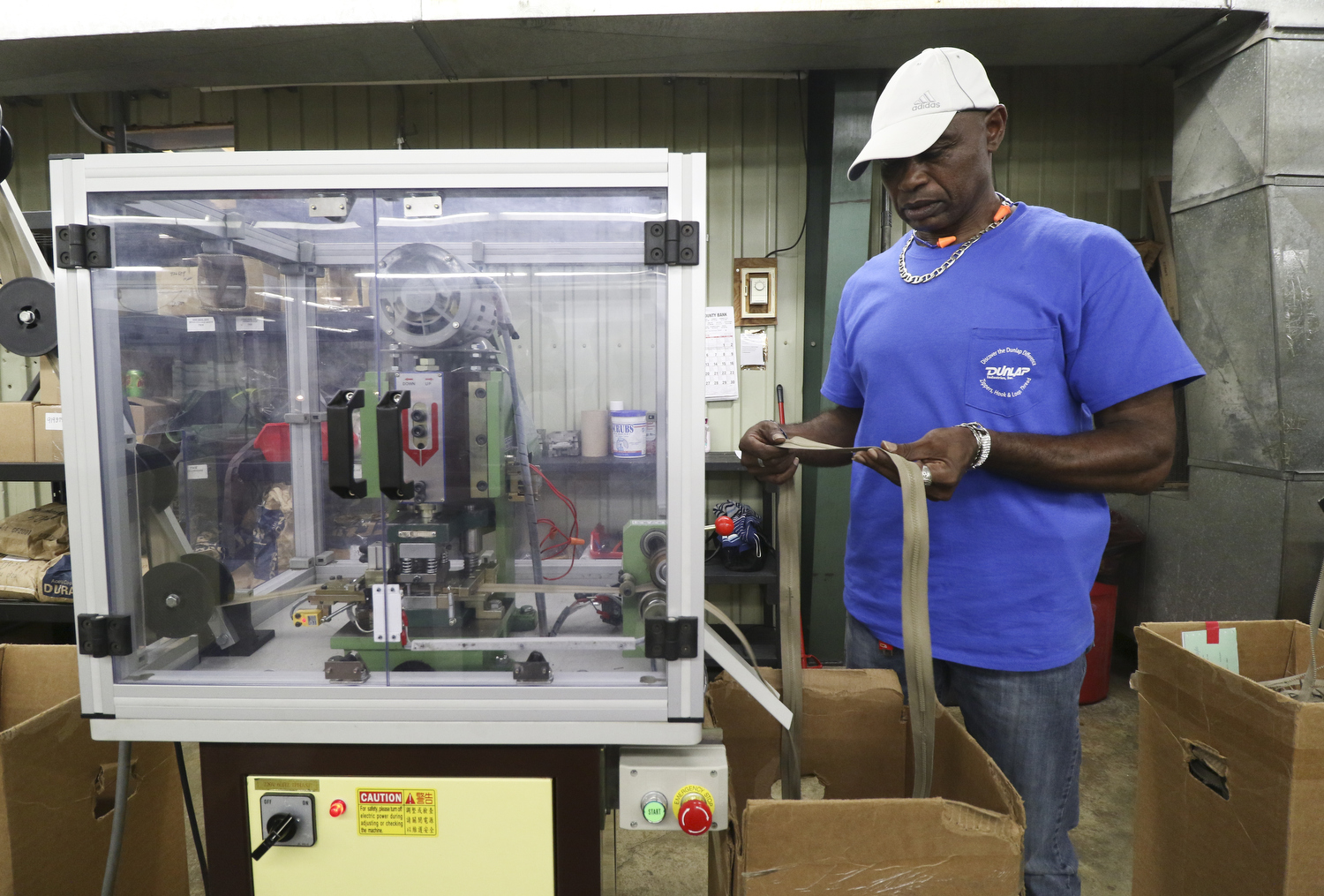 Staff Photo by Dan Henry / The Chattanooga Times Free Press- 7/25/16. Yancy Davis molds 6" zippers at Dunlap Industries on Monday, July 25, 2016. DI makes molded and coil zippers for use with U.S. Army and other high use applications.