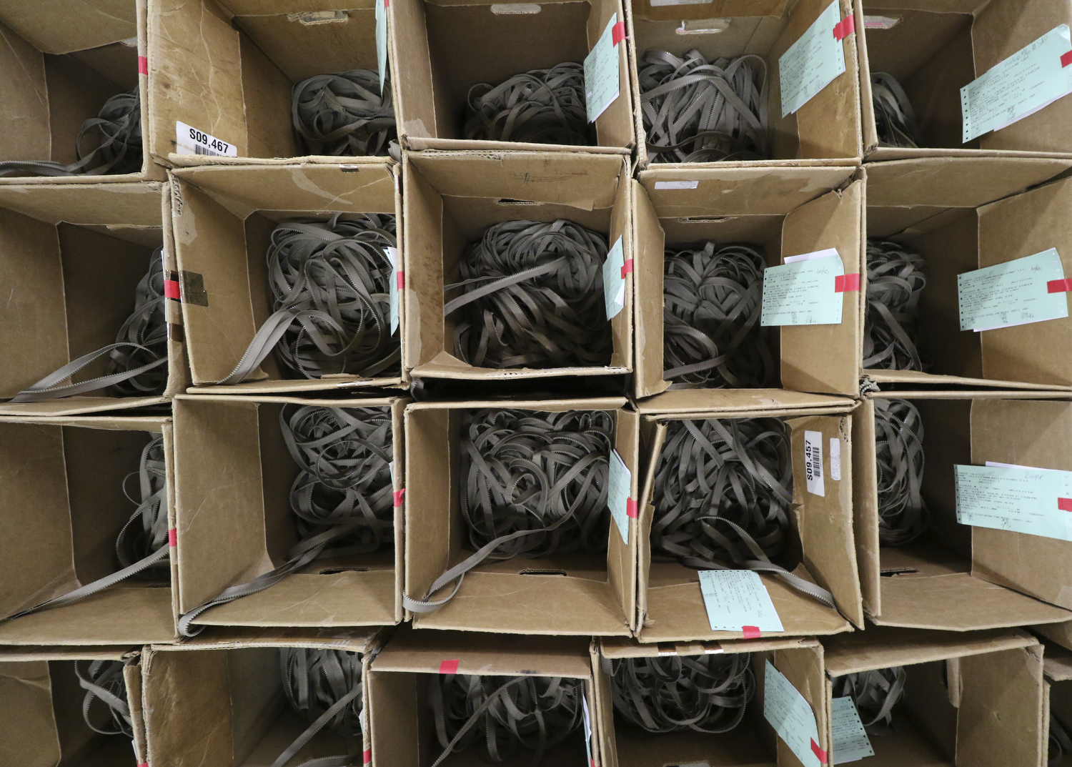 Staff Photo by Dan Henry / The Chattanooga Times Free Press- 7/25/16. Boxes of deburred zippers await the addition of sliders at Dunlap Industries on Monday, July 25, 2016. DI makes molded and coil zippers for use with U.S. Army and other high use applications.