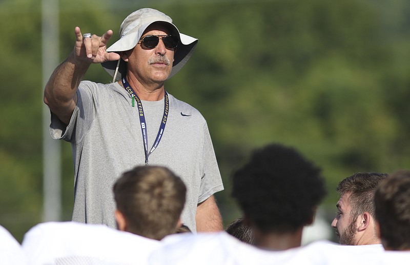 Staff Photo by Dan Henry / The Chattanooga Times Free Press- 7/25/16. Head coach Mark Mariakis works with his team at Chattanooga Christian School during the first day of practice in pads on Monday, July 25, 2016. 