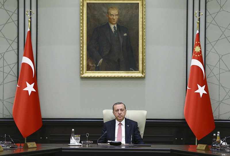 
              Under a portrait of Turkish Republic founder Mustafa Kemal Ataturk,Turkey's President Recep Tayyip Erdogan chairs the cabinet meeting, in Ankara, Turkey, Monday, July 25, 2016. Turkey on Monday issued warrants for the detention of 42 journalists suspected of links to the alleged organizers of a failed military uprising, intensifying concerns that a sweeping crackdown on alleged coup plotters could target media for any news coverage critical of the government. (Presidential Press Service, Pool via AP)
            