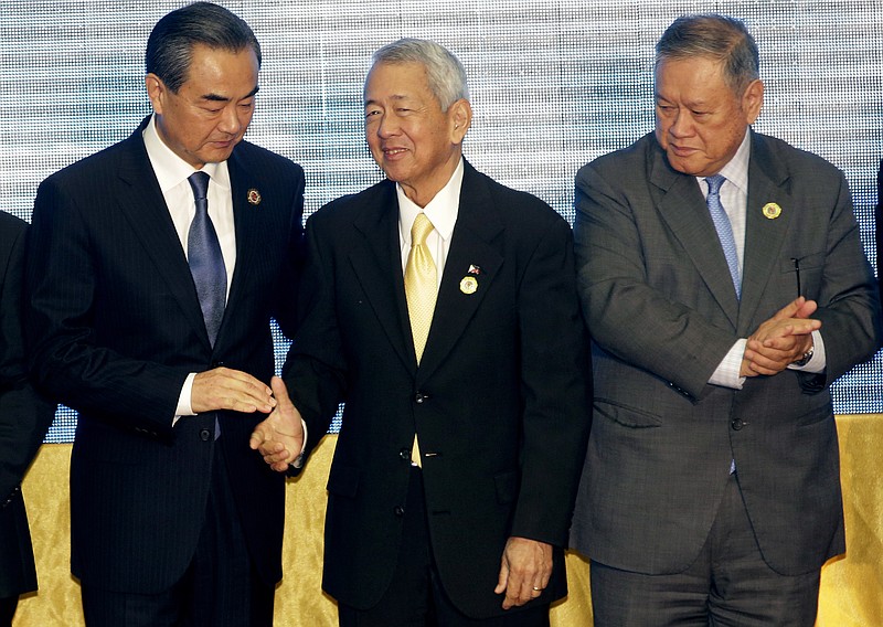 
              China's Foreign Minister Wang Yi, left, stands with Philippines Foreign Minister Perfecto Yassay, center, and Brunei's Foreign Affairs and Trade Minister Jock Seng Pehin Lim after they pose for a photo during the Association of Southeast Asian Nations (ASEAN) Foreign Ministers' Meeting in Vientiane, Laos, Tuesday, July 26, 2016. (AP Photo/Sakchai Lalit)
            