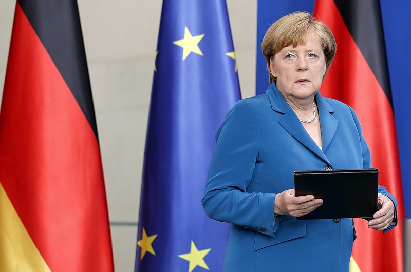 
              FILE- In this Saturday, July 23, 2016 file photo, German Chancellor Angela Merkel arrives for a statement in Berlin, Germany, on the Munich attack. Four attacks in a week — three of them carried out by asylum seekers — have left Germany on edge and Chancellor Angela Merkel's policies of welcoming refugees under renewed criticism. Anxiety over Germany's ability to cope with last year's flood of more than 1 million registered asylum seekers first surged following a series of sexual assaults and robberies in Cologne during New Year celebrations.  (AP Photo/Michael Sohn, File)
            