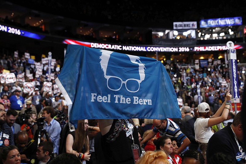 
              A delegate shows support for former Democratic Presidential candidate, Sen. Bernie Sanders, I-Vt., during the first day of the Democratic National Convention in Philadelphia , Monday, July 25, 2016. (AP Photo/Carolyn Kaster)
            