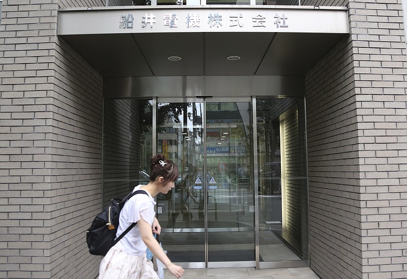 
              A woman walks past Funai Electric CO, LTD in Tokyo, Monday, July 25, 2016.   Japanese electronics maker Funai Electric Co. says it's yanking the plug on the world's last video cassette recorder. A company spokesman, who requested anonymity citing company practice, confirmed Monday that production will end sometime this month, although he would not give a date. (AP Photo/Koji Sasahara)
            