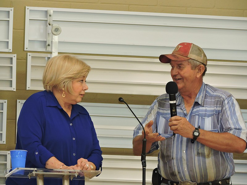 Walker County Commissioner Bebe Heiskell, left, and Rick Byrd, of Byrd Trucking, discuss why Walker County is considering selling the landfill during the Cedar Grove Community Club's Fourth of July celebration.