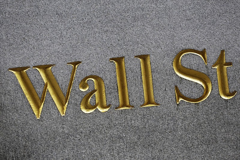 
              FILE - This Monday, July 6, 2015, file photo shows a sign for Wall Street carved into the side of a building in New York. Stocks were slightly higher in early trading on Tuesday, July 26, 2016, as investors monitor corporate earnings from the likes of Gilead, McDonald's, Texas Instruments and others. Slumping oil prices held the gains in check. (AP Photo/Mark Lennihan, File)
            