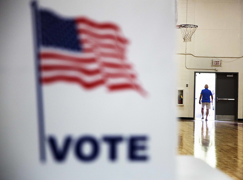 A voter leaves a polling site after casting a ballot Tuesday, July 26, 2016, in Atlanta. Two Republicans faced off for a shot at replacing a retiring west Georgia congressman as runoff elections were held across the state Tuesday, as challengers also sought to oust several incumbent state lawmakers. Georgians returned to the polls in several races that required runoffs because no candidate won more than half the vote in the May 24 primaries. 