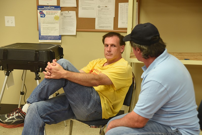Jeff Holcomb talks with his brother, Rick Holcomb at the Ringgold Voting Precinct Tuesday, July 26, 2016.