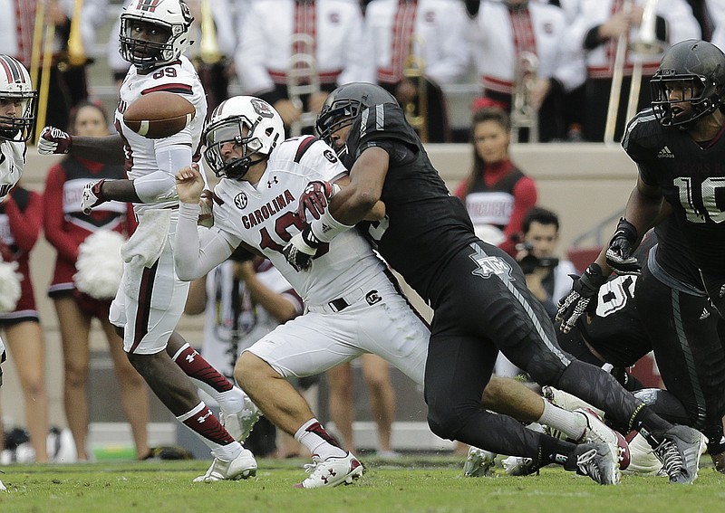 Texas A&M junior defensive end Myles Garrett, shown harassing South Carolina quarterback Perry Orth last October, has racked up 24 sacks in two seasons with the Aggies.