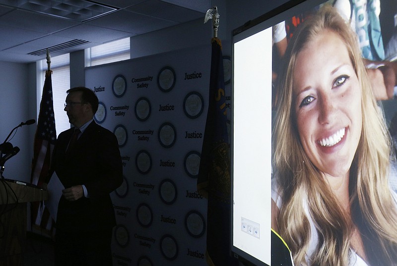
              A picture of missing person Kaylee Sawyer is displayed on a screen as Deschutes County District Attorney John Hummel speaks during a press conference on Tuesday, July 26, 2016, at the Deschutes County Courthouse in Bend, Ore. A small Northern California town was rocked by a shooting, kidnapping and carjacking on Tuesday, all allegedly committed by a man and woman from Oregon who led police on a high-speed chase before they were captured. The man, Edwin Lara, was fleeing his home state after being implicated Monday in the disappearance of a 23-year-old. Lara was charged with murder Tuesday in the death of Sawyer, of Bend, Ore. (Joe Kline/The Bulletin via AP)
            