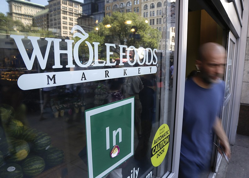 
              FILE - In this June 24, 2015, file photo, a shopper leaves a Whole Foods Market store in New York's Union Square. Whole Foods reports financial results Wednesday, July 27, 2016. (AP Photo/Julie Jacobson, File)
            