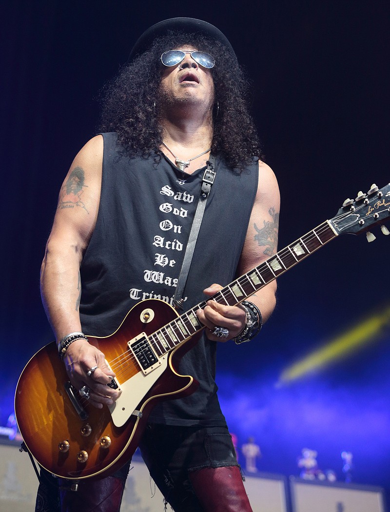 
              FILE - In this May 16, 2015 file photo, guitarist Slash, formerly of the band Guns N' Roses, performs in concert during the MMRBQ Music Festival 2015 in Camden, N.J. Slash made a surprise appearance Friday, July 22, 2016, while the pre-teen band for the musical "School of Rock"was practicing the Guns N’ Roses song “Sweet Child O’ Mine.”  (Photo by Owen Sweeney/Invision/AP, File)
            