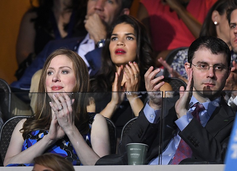 
              Chelsea Clinton, daughter of Democratic Presidential candidate Hillary Clinton, left, applauds alongside her husband Marc Mezvinsky during the second day of the Democratic National Convention in Philadelphia , Tuesday, July 26, 2016. (AP Photo/Mark J. Terrill)
            