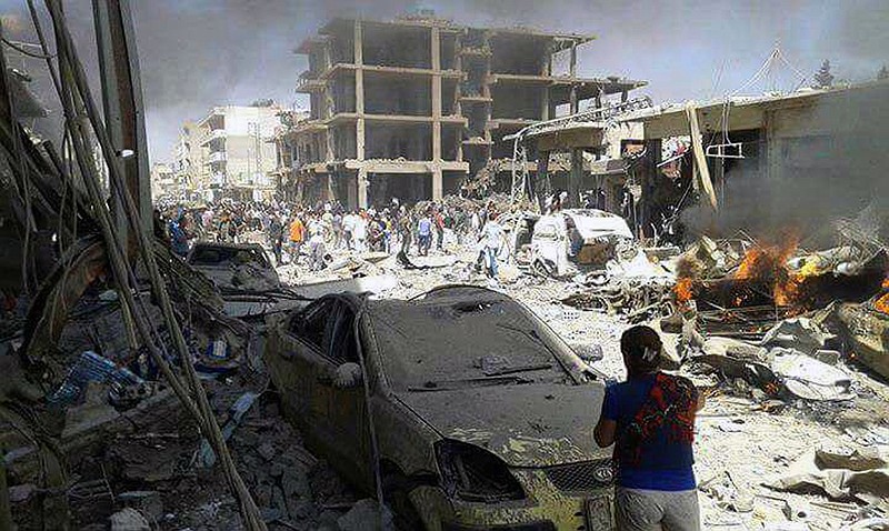
              In this photo released by the Syrian official news agency SANA, Syrians inspect damages after deadly twin bombings struck the town of Qamishli, Syria, Wednesday, July 27, 2016. The bombings struck a crowd in the predominantly Kurdish town in northern Syria on Wednesday, killing and wounding dozens of people, Syria's state-run news agency and Kurdish media reported. State-run TV said a truck loaded with large quantities of explosives blew up on the western edge of the town of Qamishli, followed by an explosives-packed motorcycle few minutes later in the same area. (SANA via AP)
            