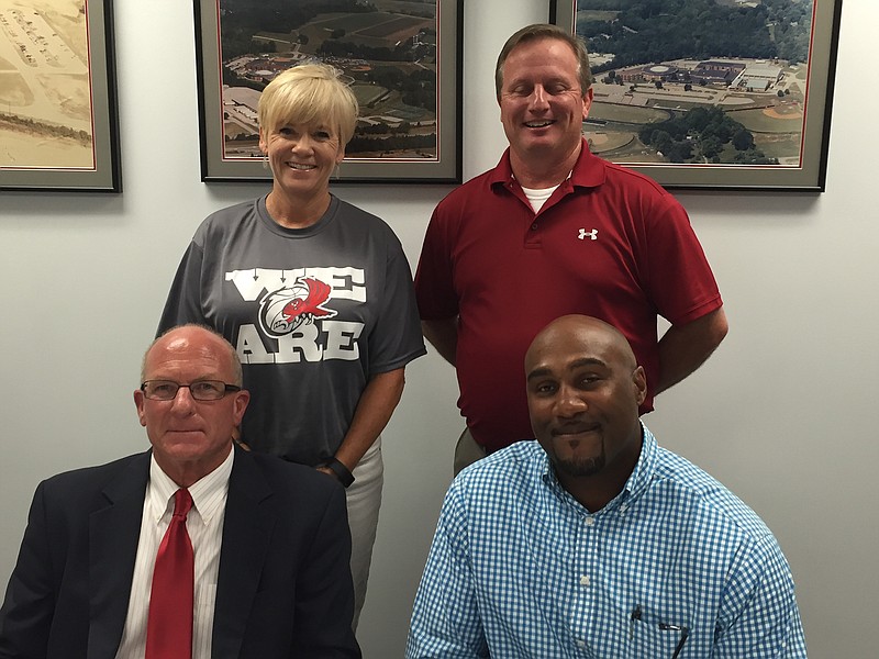 New Ooltewah basketball coach Jay Williams, seated left, and his assistant, Theanthony Haymon, seated right, were introduced to returning team members by new principal Robin Copp, standing left, and new athletic director Brad Jackson.