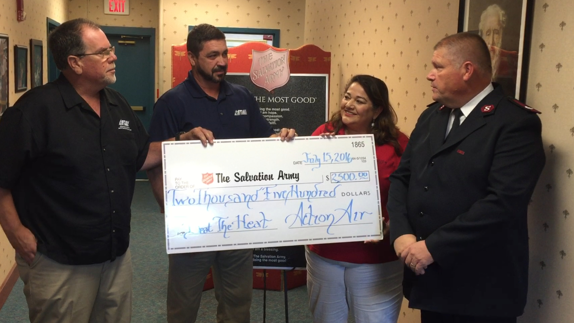 Action Air owners Kevin Horne and Eric Dunn, from left, present a $2,500 check to the Salvation Army to help fund the agency's Beat the Heat program. With them are Kimberly George, Salvation Army director of marketing, and Salvation Army Maj. Robert Lyle.